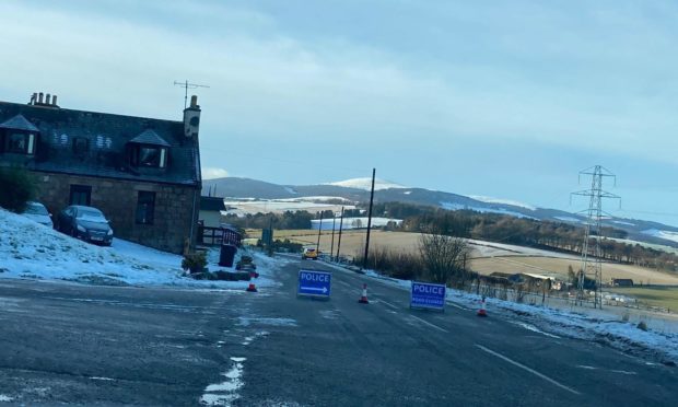 Police close the road near Paterson's Stoves, B9119.. Aberdeenshire.