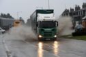 A lorry splashes through floodwater on the A90 at Boddam. Picture by Kenny Elrick
