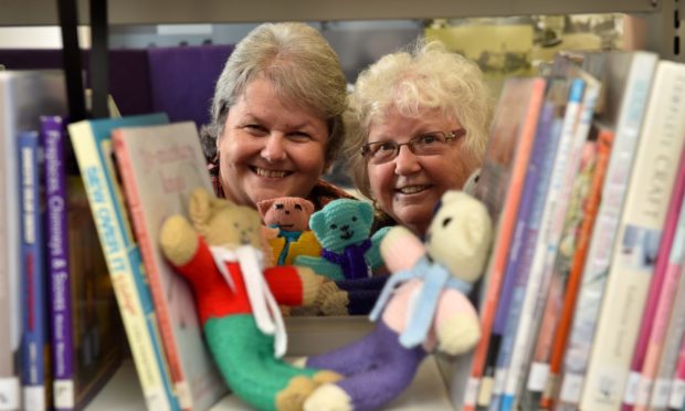 Councillors Anne Stirling and Anne Simpson with some bears knitted by the Live Life Aberdeenshire libraries knit and natter groups.