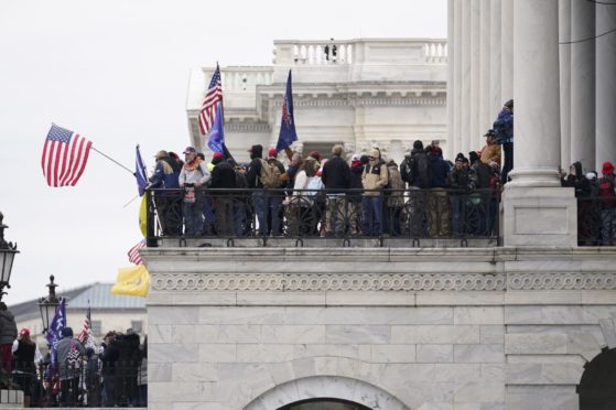 Trump supporters gather outside the Capitol, Wednesday, Jan. 6, 2021, in Washington. As Congress prepares to affirm President-elect Joe Biden's victory, thousands of people have gathered to show their support for President Donald Trump and his claims of election fraud. (AP Photo/Manuel Balce Ceneta)