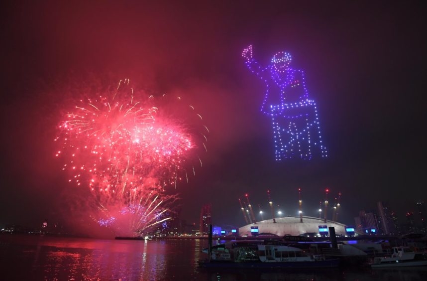Fireworks and drones illuminate the night sky over London as they form a light display as London's normal New Year's Eve fireworks display was cancelled due to the coronavirus pandemic. PA Photo. Picture date: Thursday December 31, 2020. Photo credit should read: Victoria Jones/PA Wire