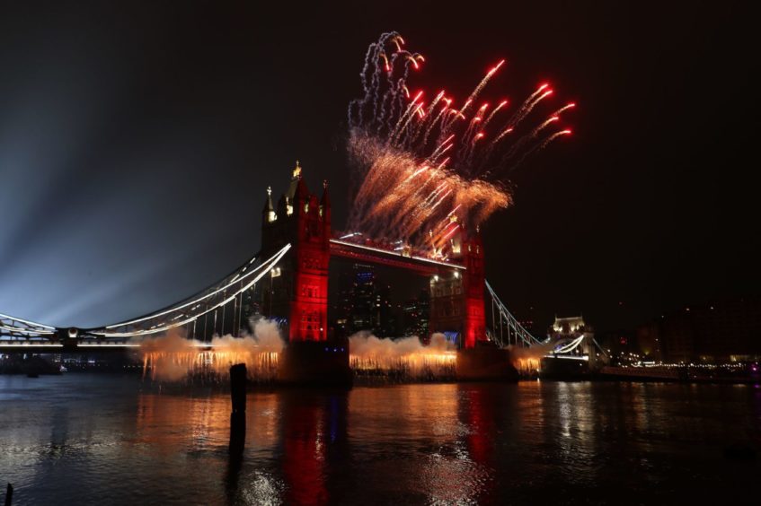 A light display over the River Thames and fireworks on Tower Bridge