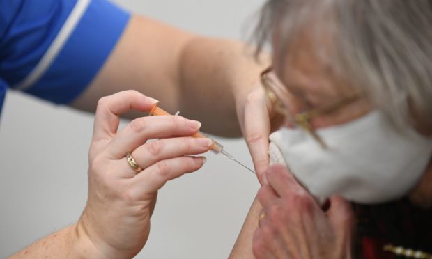 A patient receives her first Covid jab.