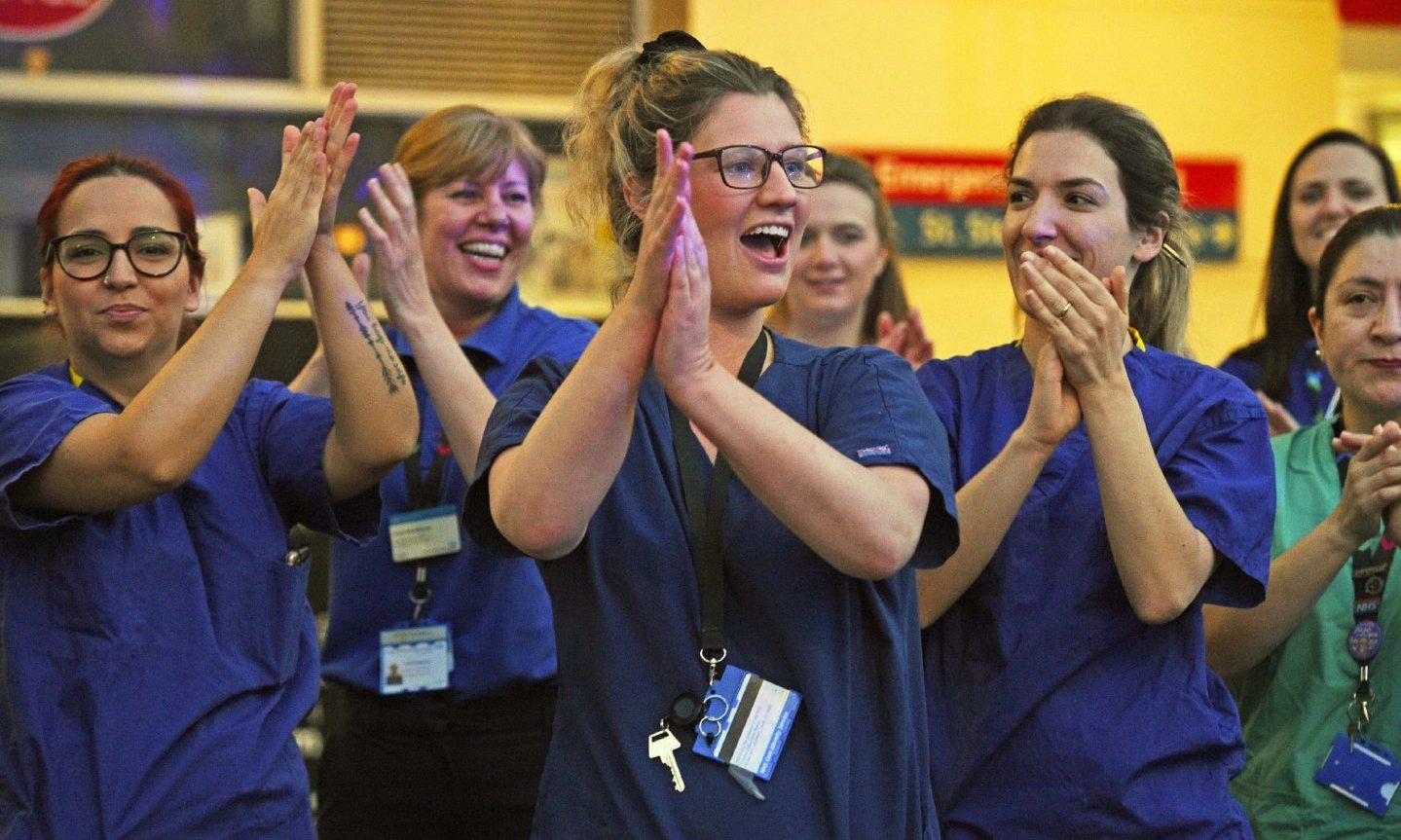 Hospital staff in London take part in the Clap for Carers initiative to applaud NHS workers fighting the coronavirus pandemic.