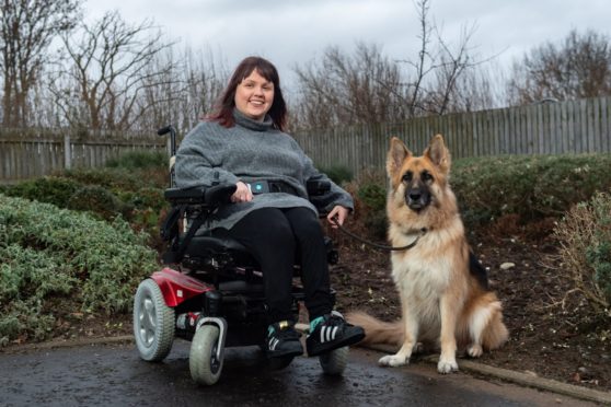 Chloe O'Hare and her dog, Gucci are pictured at home.