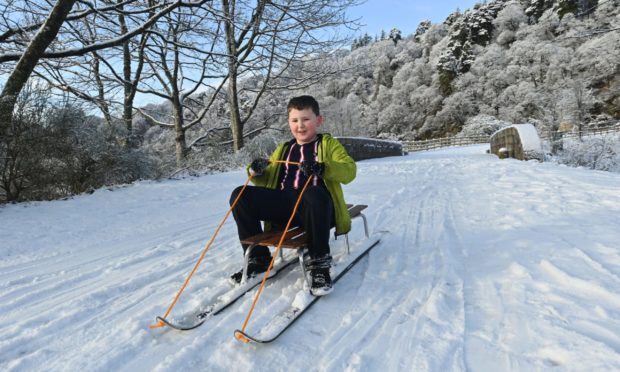 Kyle Saxton sledges at Craigellachie Bridge. More snow is forecast for the Highlands.