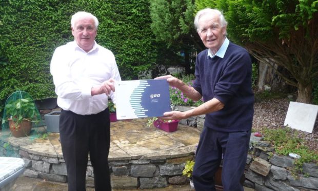 John MacKenzie, chairman of Badeoch Shinty Memories (left) recently received a laptop from Donnie Grant, Shinty Memories Scotland ambassador