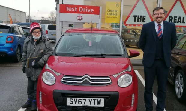 Maurice Dey and Stuart Rourke, the manager at Arnold Clark with car bought thanks to the fundraiser.