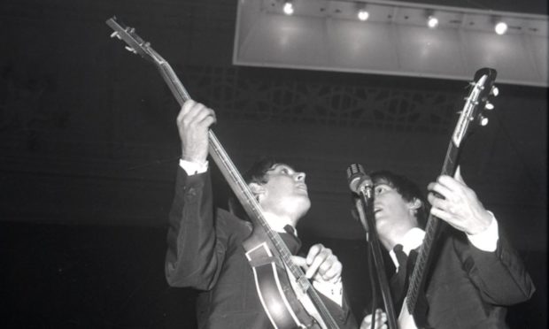 Paul McCartney and George Harrison on stage in Dundee.