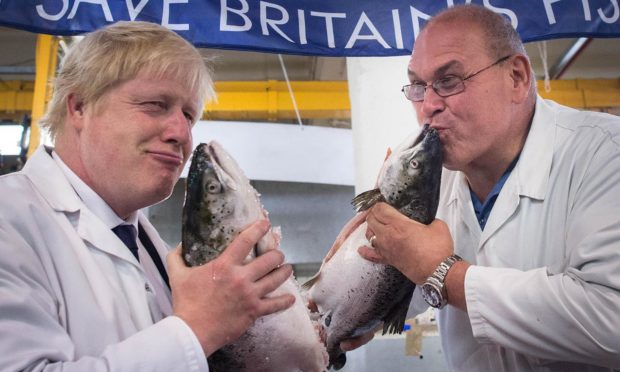 Boris Johnson kisses a salmon on the Brexit campaign trail
