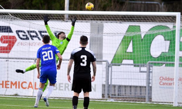 Rory McAllister's header loops over Peterhead goalkeeper Josh Rae.