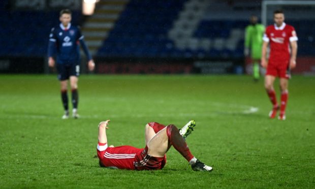 Aberdeen's Ross McCrorie lies injured on the Global Energy Stadium pitch. Picture by Darrell Benns