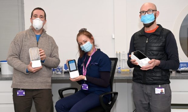 Pictured are from left, Kieran Gullett, Liliana Chaparro and David Leiper of TAC Healthcare Group with their new Lumira  Dx testing kits which are used for Covid testing offshore.