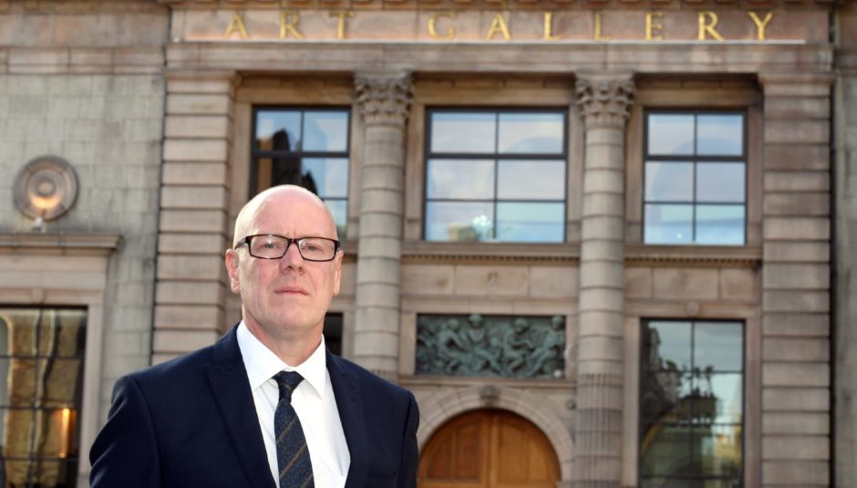 Aberdeen Central MSP, Kevin Stewart, outside Aberdeen Art Gallery, a building now with the same A listed status as the eight flat blocks