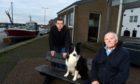Moray MP Douglas Ross with John Mains who was part of the group behind the Burghead harbour shelter committee and his Collie Marsh.