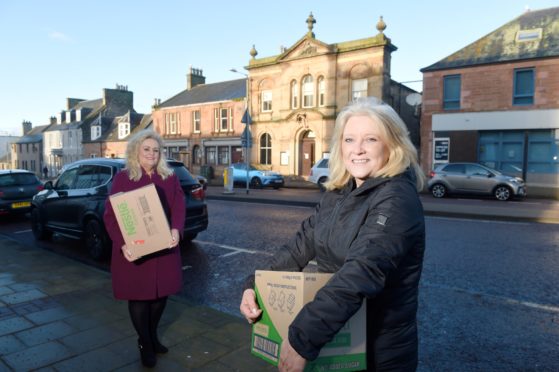 Highland councillors Maxine Smith and Pauline Munro helping with food distribution in the Alness and Invergordon.