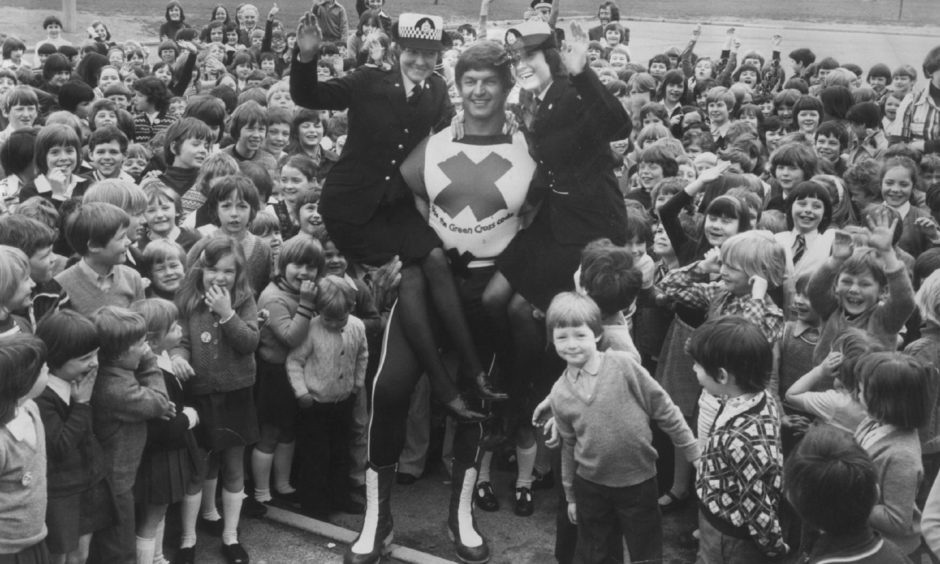 Grampian Police cadets Moira Marshall and June Duncan got a lift from Green Cross Code man Dave Prowse in Ma  1977 when he visited Dyce Primary School to spread the road safety message.