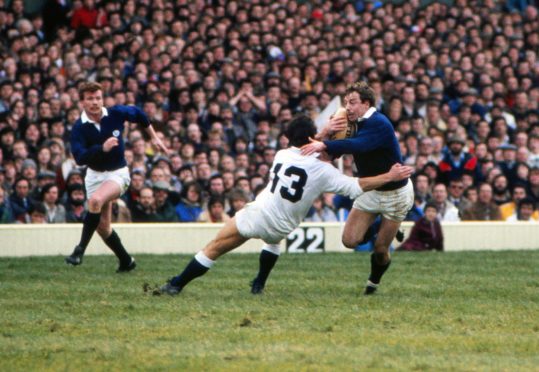 Mandatory Credit: Photo by Colorsport/Shutterstock (3166030a)
Rugby Union - 1983 Five Nations Championship - England 12 Scotland 22 First in sequence: Scotland's Roy Laidlaw evades the tackle of Huw Davies (#13) on the way to scoring his suberb solo try at Twickenham 05/03/1983 5N 1983: England 12 Scotland 22
Sport
