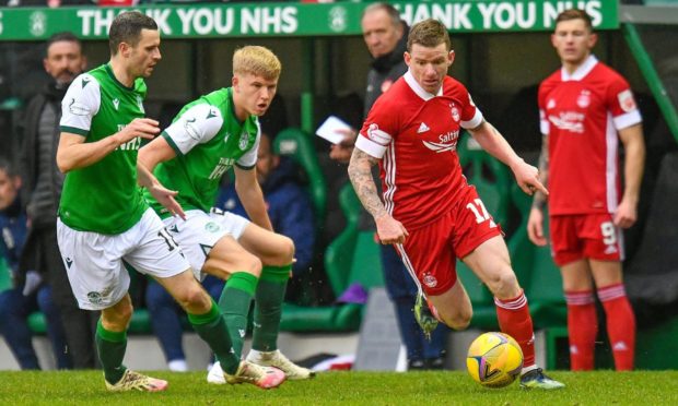 Jonny Hayes cuts inside Jamie Murphy (18) and Josh Doig (25) of Hibernian.