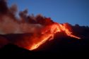 Italian volcano Mount Etna erupts, spewing smoke and ash into the sky. Angela Platania/Shutterstock