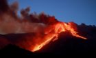 Italian volcano Mount Etna erupts, spewing smoke and ash into the sky. Angela Platania/Shutterstock