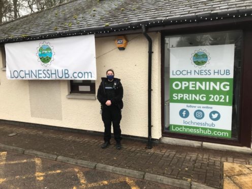 A police officer is pictured outside the vandalised toilets in Drumnadrochit.