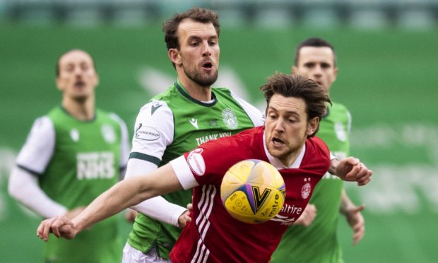 Aberdeen's Ash Taylor competes with Christian Doidge during the Scottish Premiership match against Hibernian.