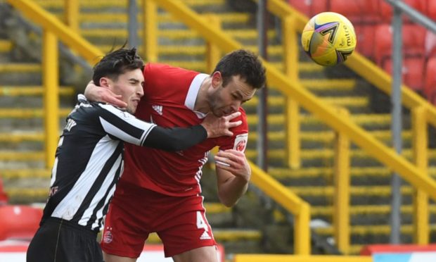 Aberdeen's Andy Considine (R) rises for a header.