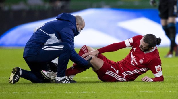 Aberdeen's Fraser Hornby receives treatment.