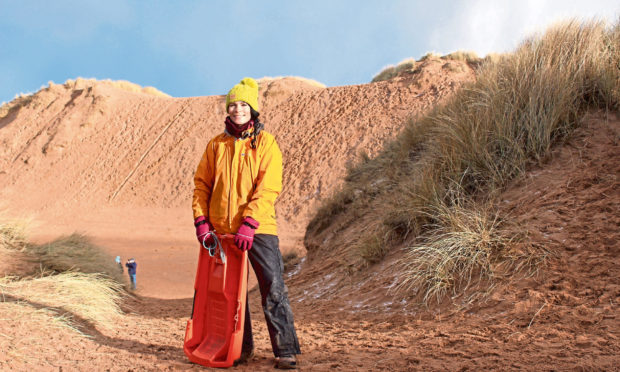 Gayle goes sledging on dunes at Balmedie Beach in Aberdeenshire.