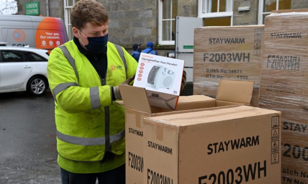 An engineer from SGN looks out portable heaters for Keith and Huntly residents affected by the gas outage.