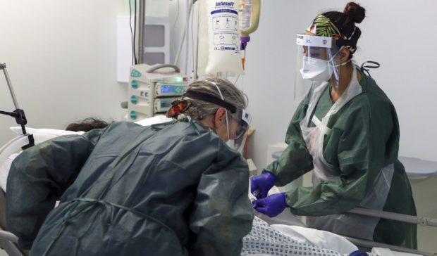 Nurses check on a Covid patient in intensive care. Picture by Steve Parsons/PA Wire
