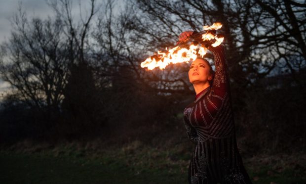 Fire performer Dawn Bryant practices at a park near her home in Birmingham. Picture date: Thursday February 11, 2021. PA Photo. The fire performer has been forced to completely 360 and take work as a carer due to the Covid-19 pandemic. Dawn Bryant used to do a large number of international choreographed shows including fire breathing, pyrotechnics and fire spinning, accompanied by music. See PA story HEALTH Coronavirus Careers. Photo credit should read: Jacob King/PA Wire