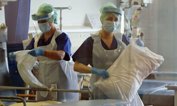 Nurses change bed clothes at the Mater Hospital Covid-19 recovery ward in Belfast.