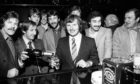 Former Dons manager Ally MacLeod pours a glass of champagne for Aberdeen's sharpshooter Joe Harper at the opening of Joe Harper's Lounge, Union Street, in 1980 while other members of the Dons team look on.