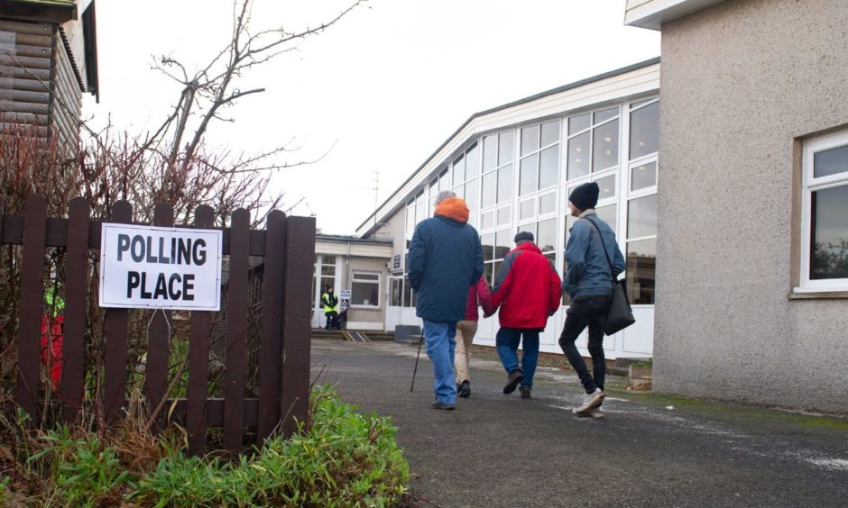 Courier News - Dundee  - Louise Gowans story - CR0017188 - General voting day pics, shots of people heading to the polls. Picture shows; voters heading into and out of a polling station in St Andrwews, Canongate Primary School, St Andrews, 12th December 2019, Kim Cessford / DCT Media.