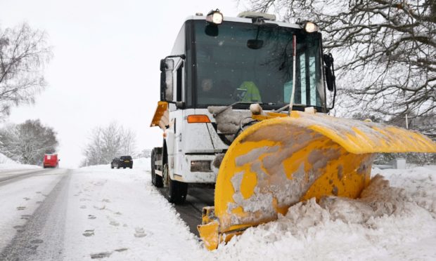 A gritter clears snow.