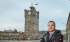 Chairman of Dufftown Community Association, Fraser McGill with the clock tower in the background.