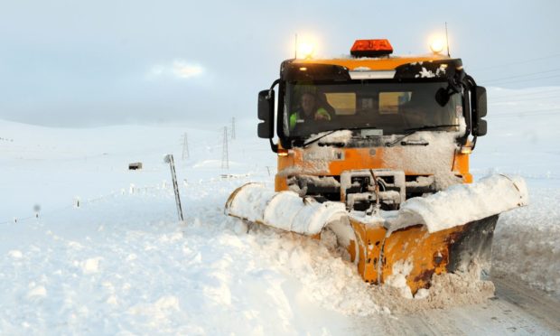 A snow plough at work in the Highlands