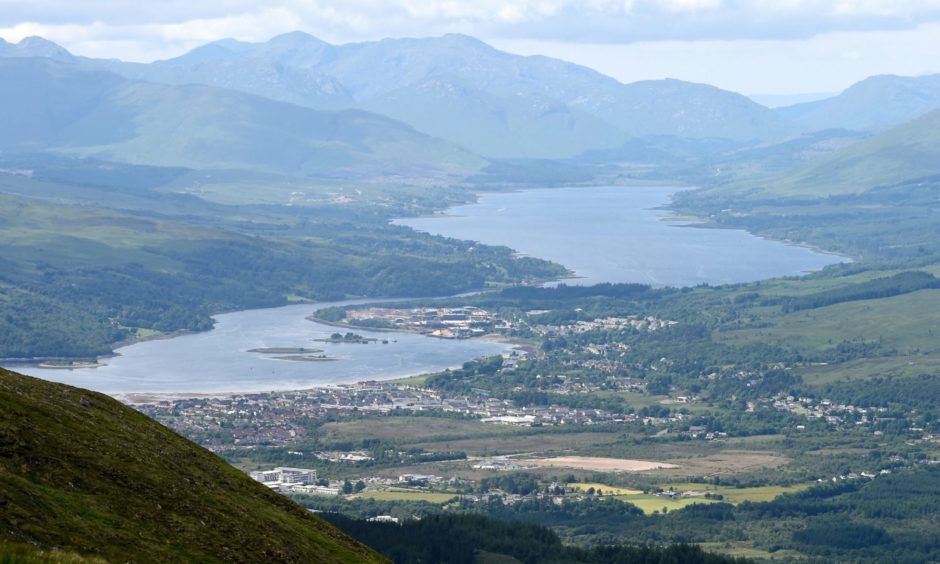 Fort William, Loch Linnhe (left) with the village of Caol and then Loch Eil in the distance.Bottom left of the photograph is Lochaber High School with the Police Station lower centre and the area planned for the new Belford Hospital in the centre of the photograph. Also to be seen between the two sea lochs is the Annat Point Industrial Estate and the BSW Timber sawmill. The road on the right past Loch Eil leads to Glenfinnan and then Mallaig.