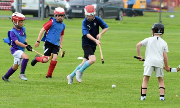 Young members of the Inverness Shinty Club play a demonstration game.