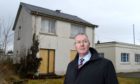 Councillor Duncan Macpherson at the empty janitor's house on Planefield Road, Inverness