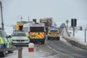 The police provide help for cars stuck on the A835. Picture from Bear Scotland