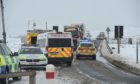 The police provide help for cars stuck on the A835. Picture from Bear Scotland