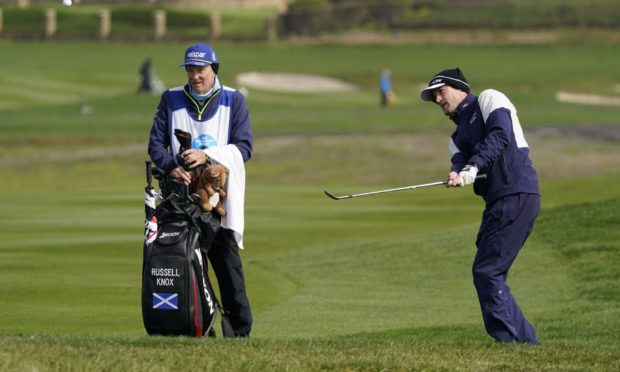 Russell Knox chips the ball onto the sixth green of the Pebble Beach Golf Links during the third round.