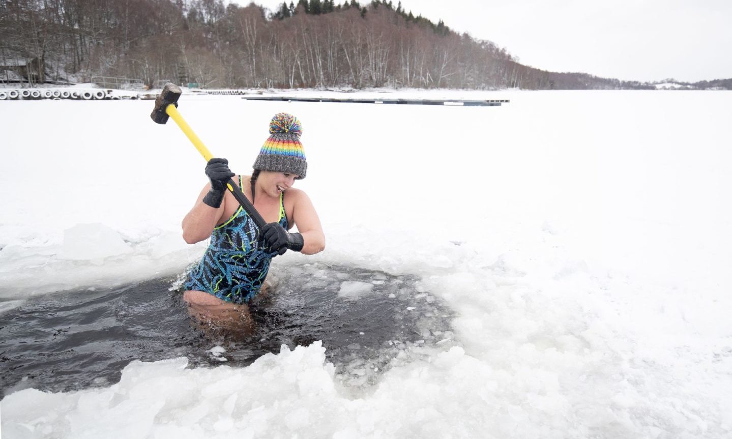 Highland swimmer uses a sledgehammer and axe to break the ice before