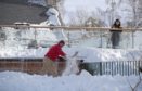 A man clearing snow in Braemar on February 11.