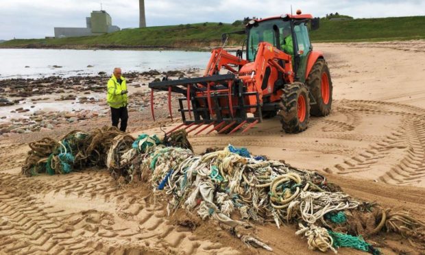 Aberdeenshire Council workers removing a one-tonne ghost net at Sandford Bay in 2019.