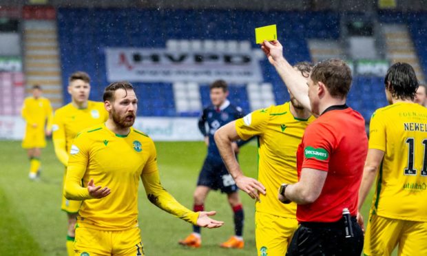 Referee John Beaton books Martin Boyle during Ross County's defeat to Hibs
