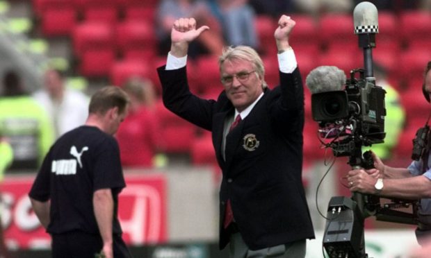 Aberdeen manager Ebbe Skovdahl cheers on the fans at his first game in charge.